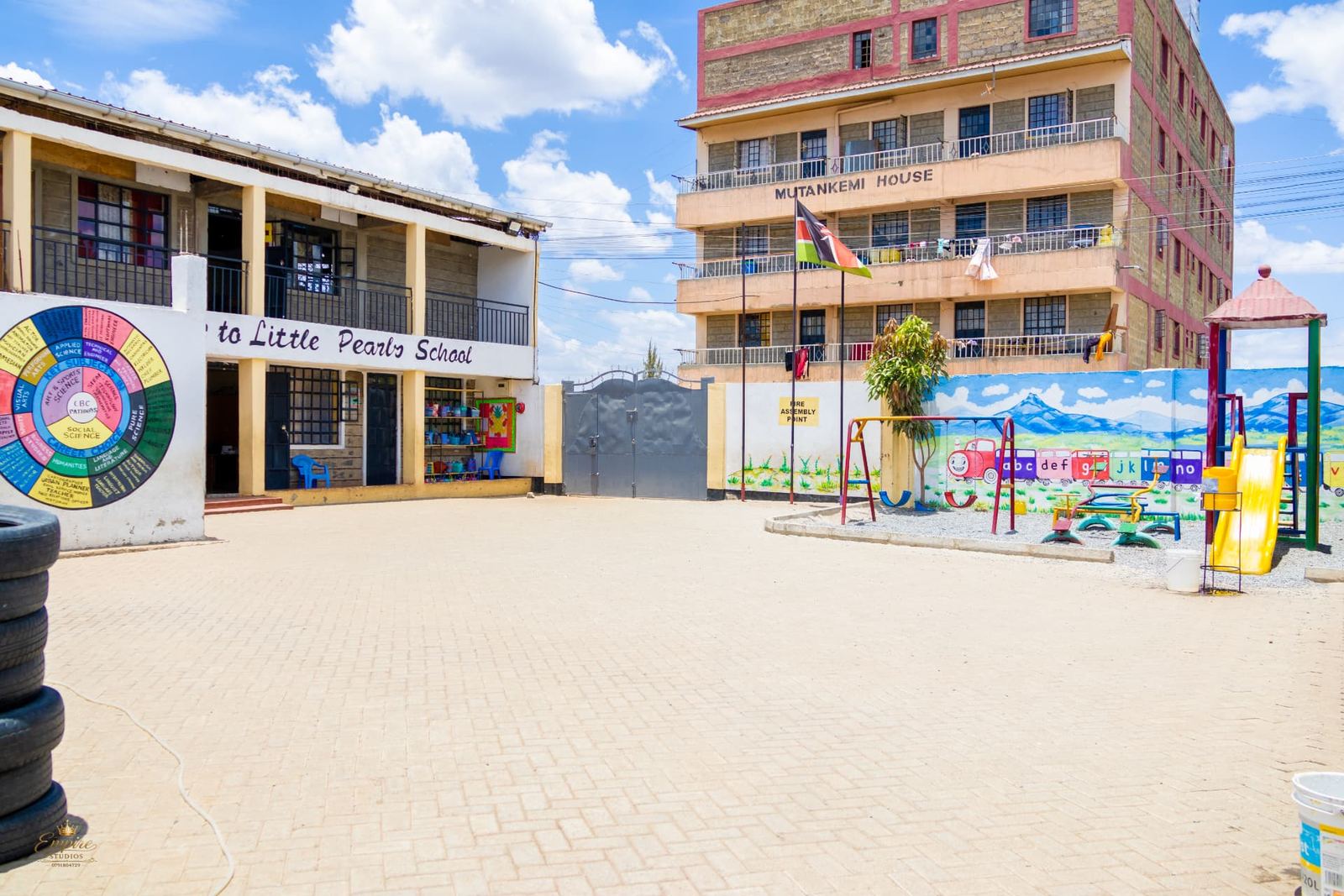 The Little Pearls School courtyard, outdoor play area and Kenyan flag